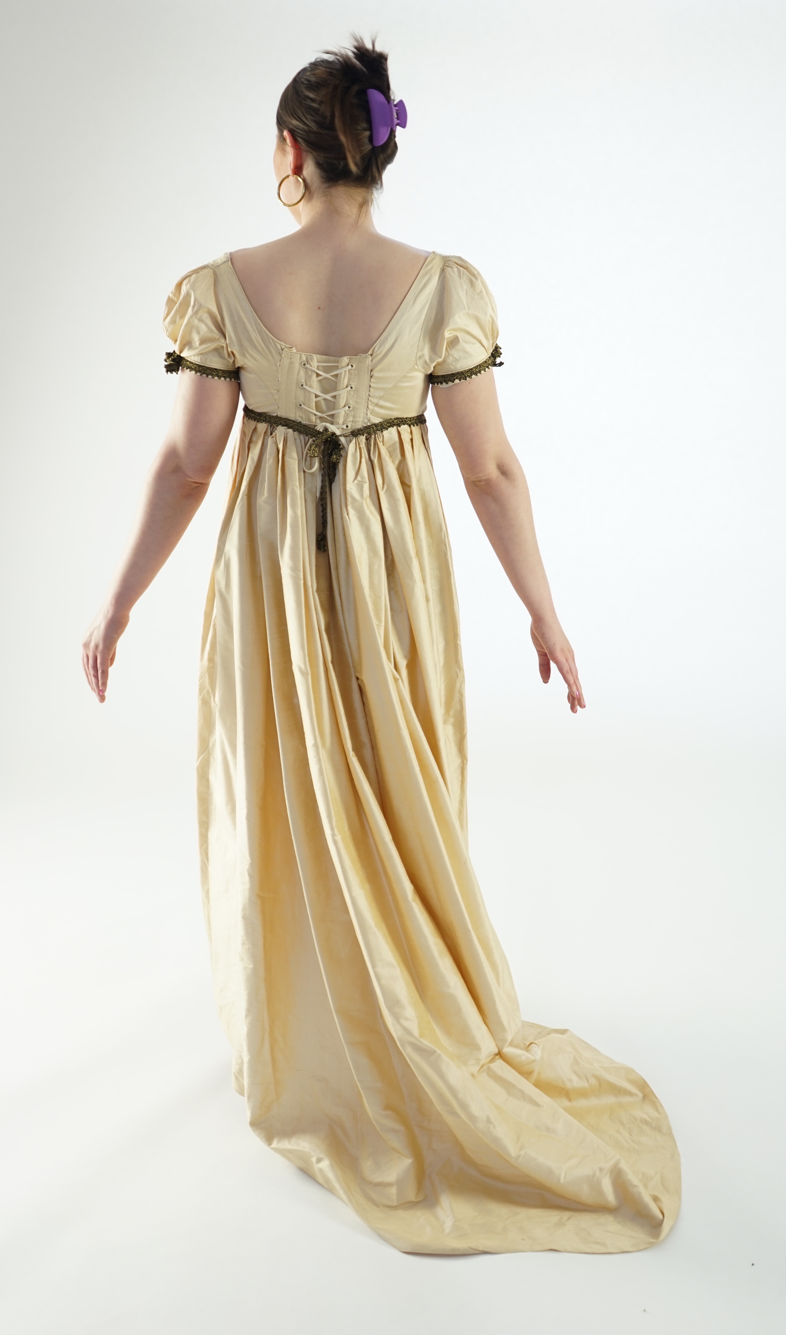 A lady's Regency style day dress in cream silk with black lace trim (lacing at back). Ex London Festival Opera 'Cosi fan tutte'